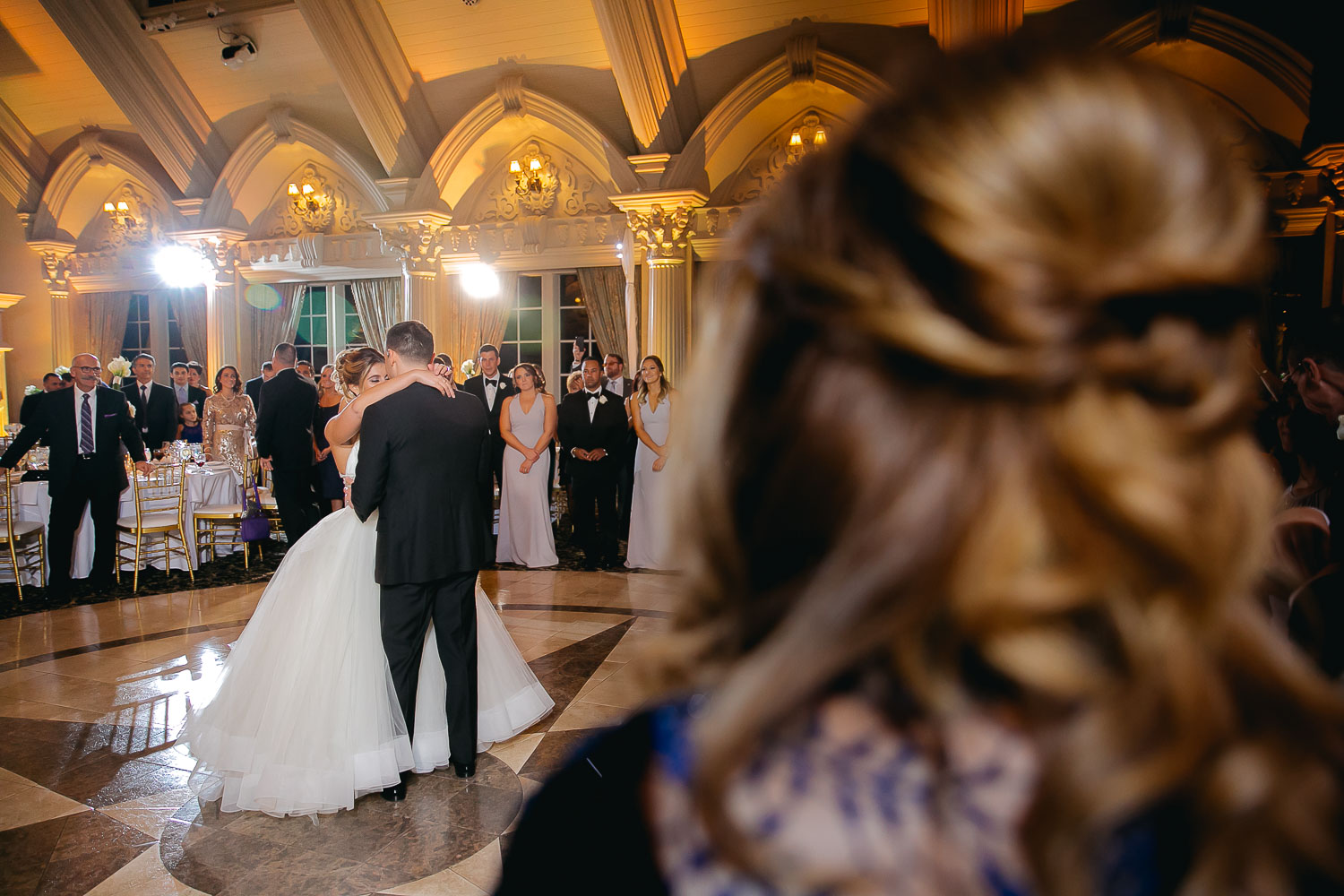 bride and groom dancing first dance in ballroom