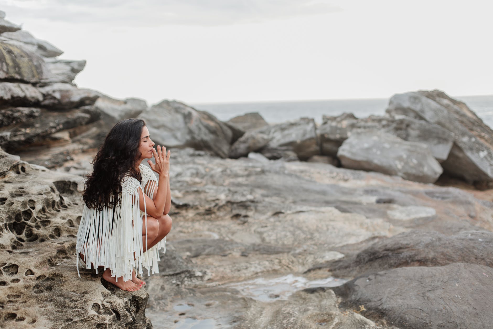 woman meditating at beach