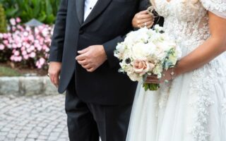father of the bride and bride arm in arm