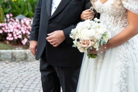 father of the bride and bride arm in arm