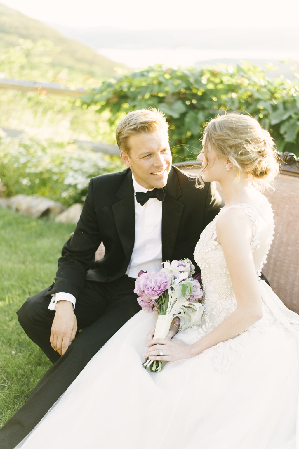 bride and groom sitting on couch