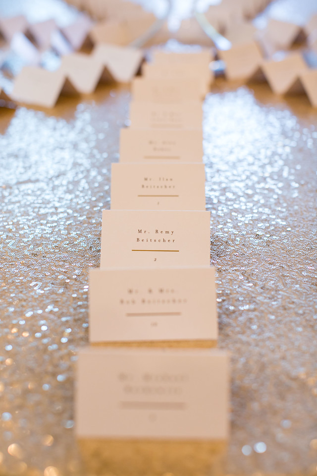 escort cards on sequin tablecloth