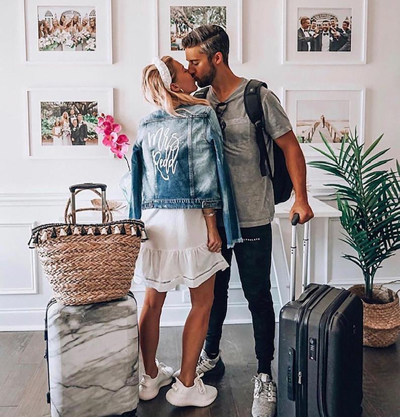 married couple kissing with jean jacket on