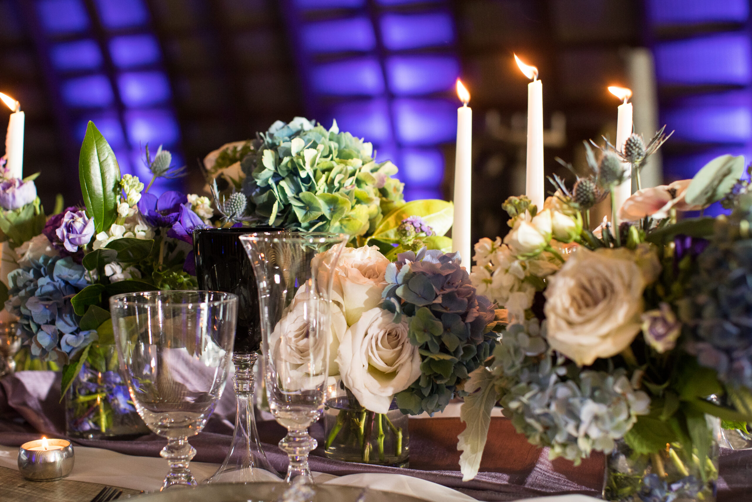 blue and purple lighting flowers long table