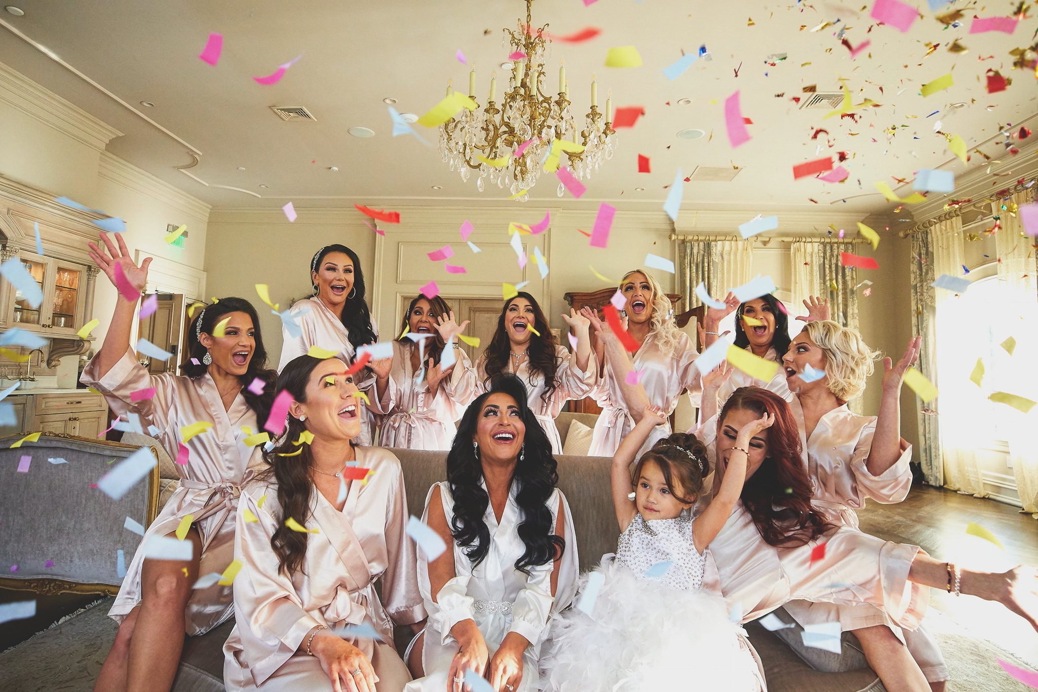 picture of bride and bridesmaids throwing confetti