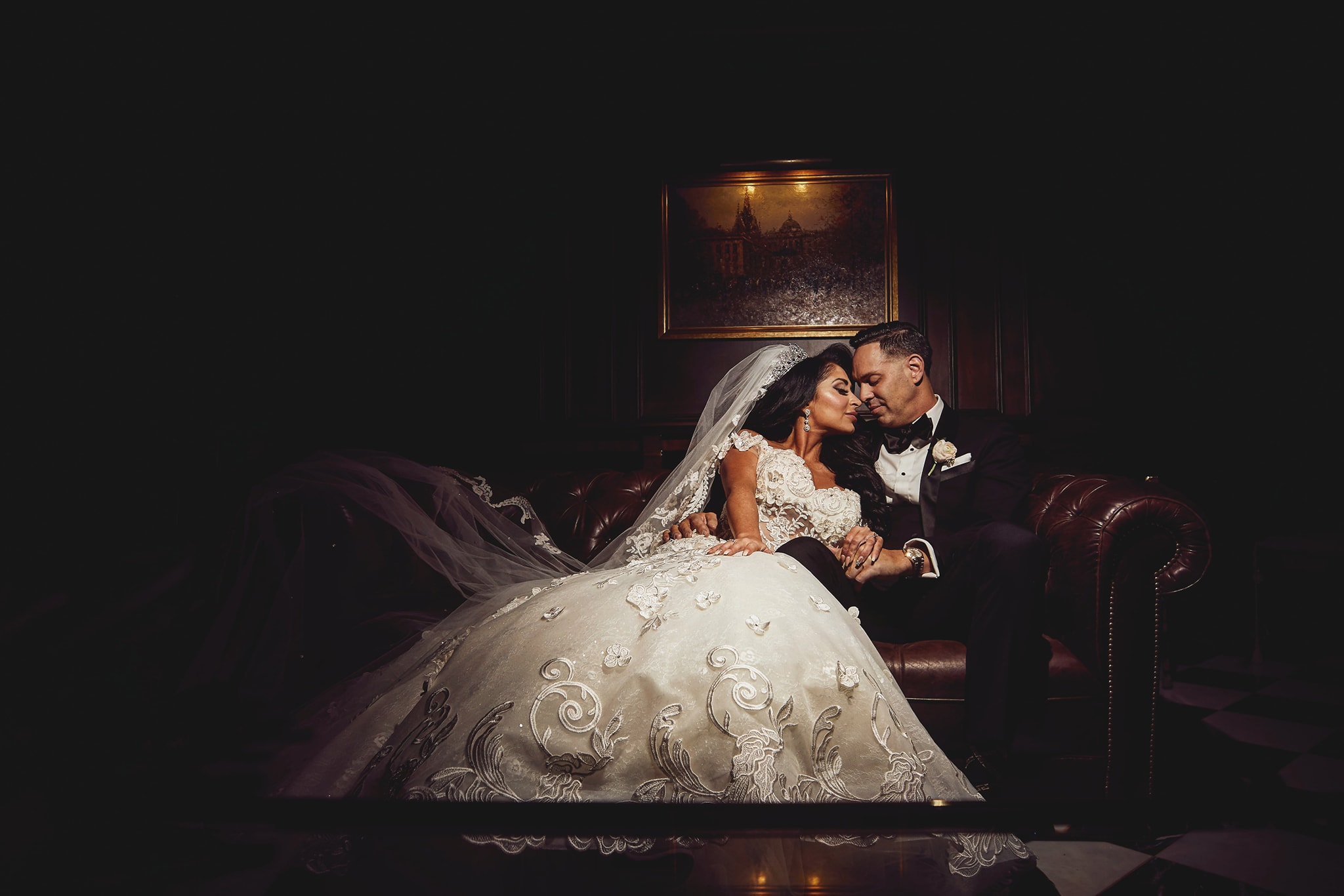 bride and groom sitting on couch