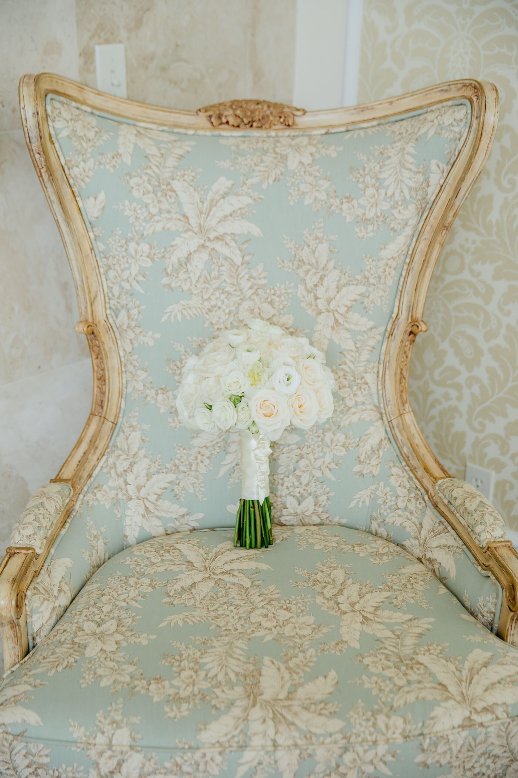 white bridal bouquet on blue chair