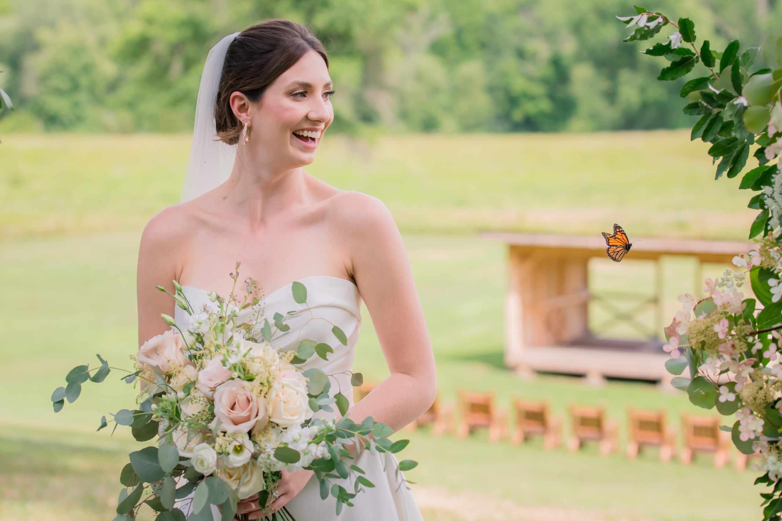 butterfly flying past bride holding bouquet