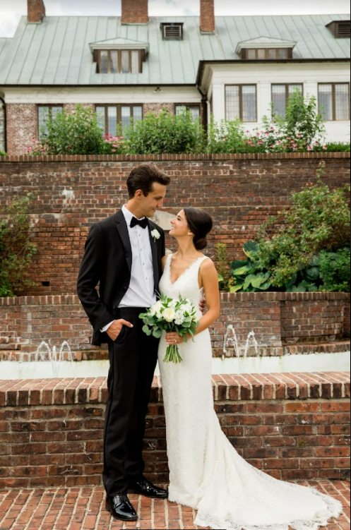 bride and groom with bouquet outside