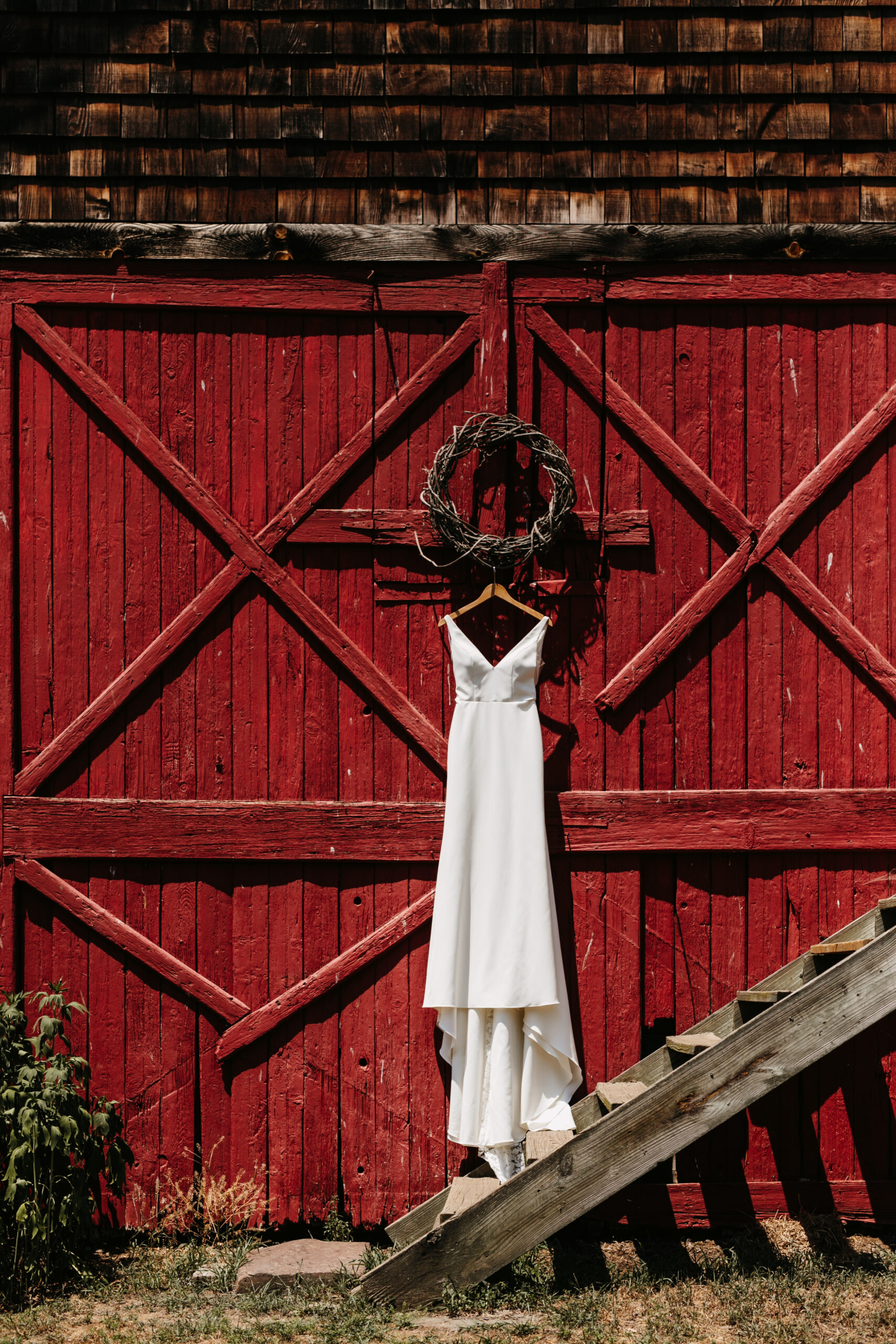 wedding gown on red barn