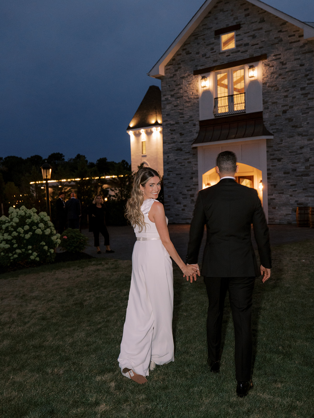 bride and groom walking inside from outside