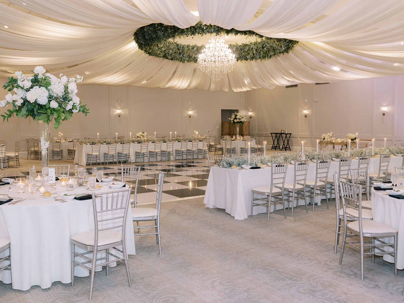 full room shot of wedding with green white black