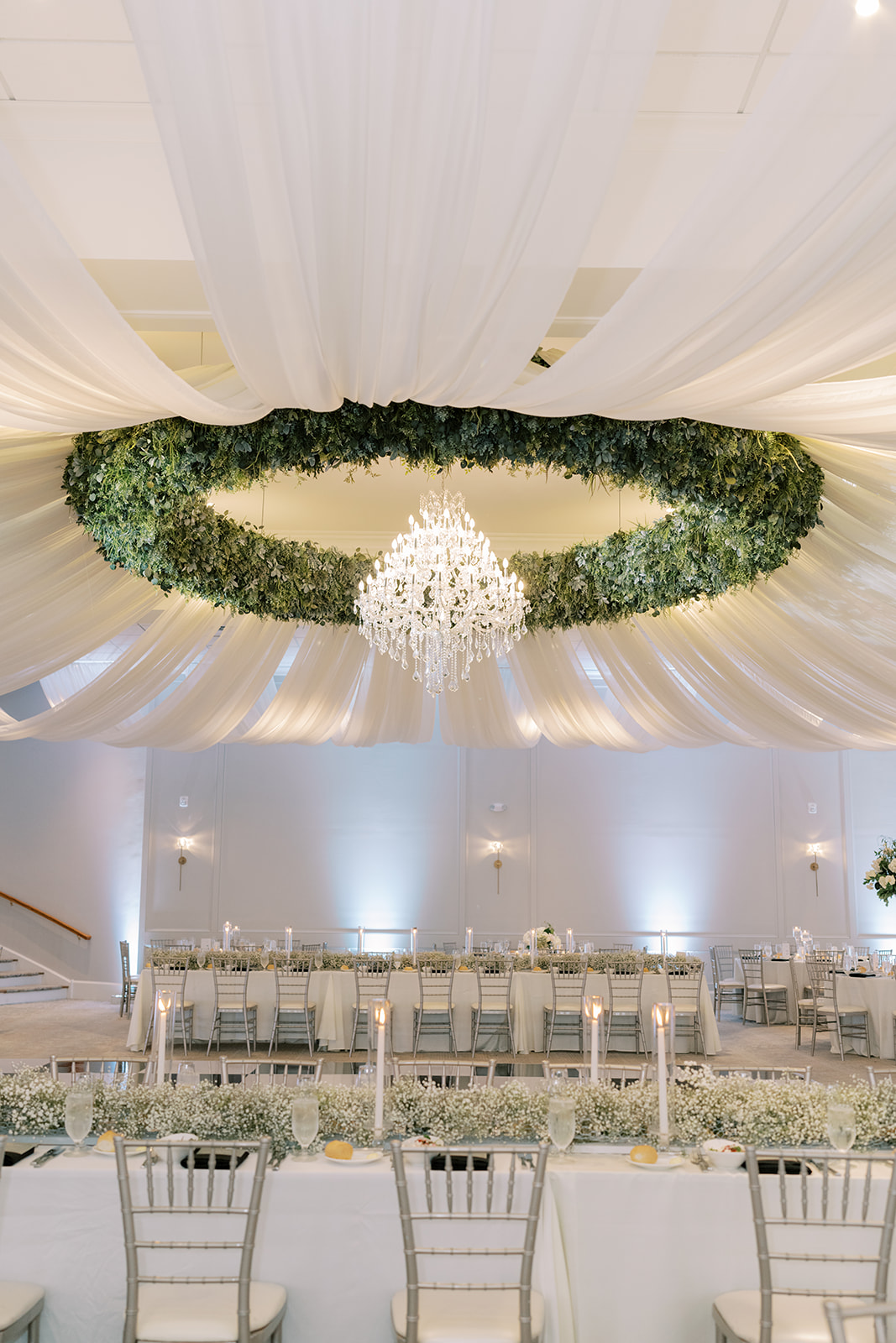 ceiling shot of greenery and tulle at wedding venue
