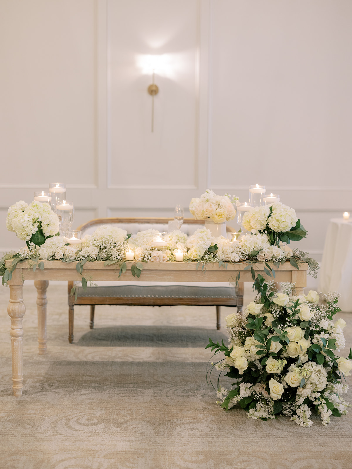 sweetheart table at wedding covered in flowers