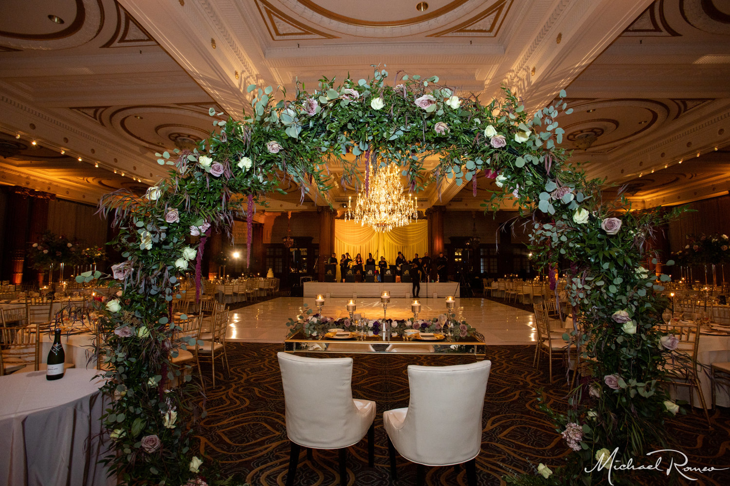 sweetheart table with greenery arch