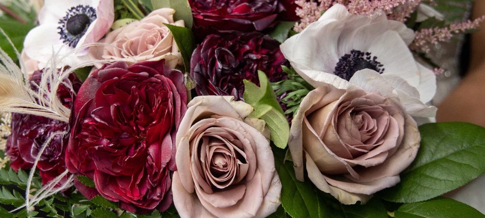 winter bridal bouquet with reds, plums, and pink