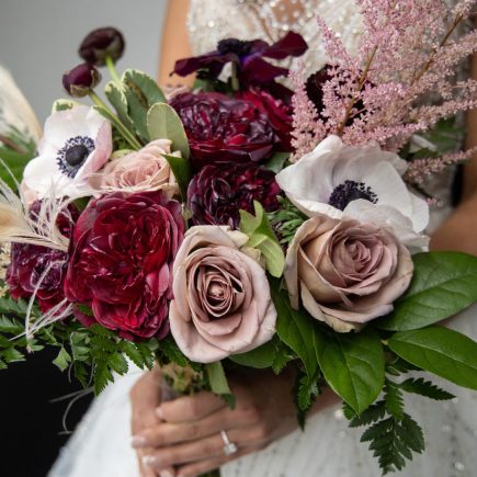 winter bridal bouquet with reds, plums, and pink
