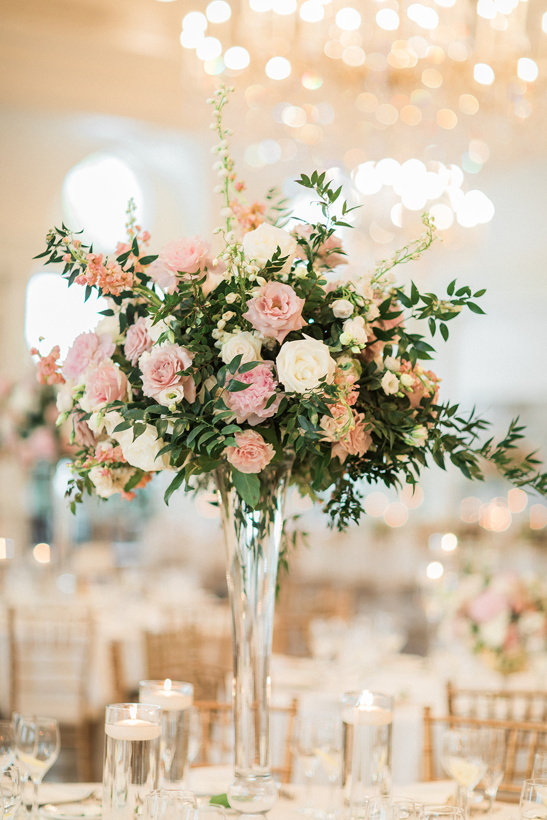 tall centerpiece with roses and greenery