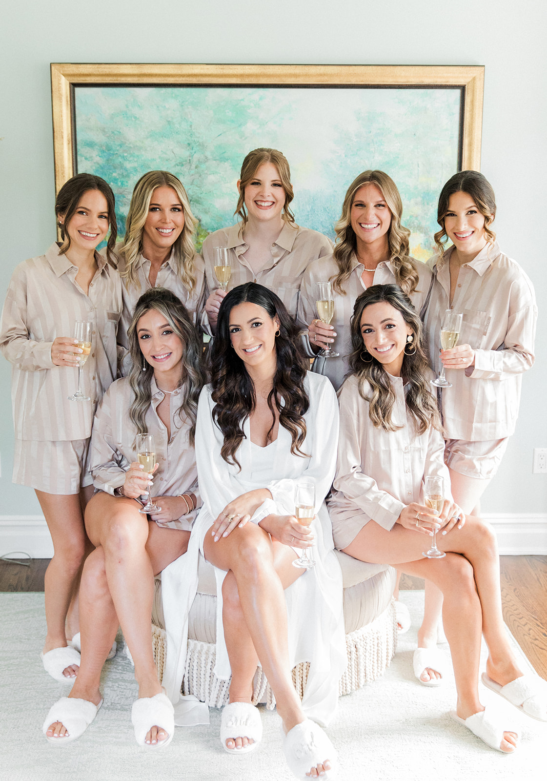 bride and bridesmaids in robes getting ready