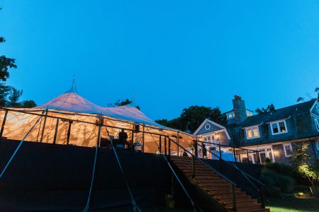 backyard wedding tent at night with lights