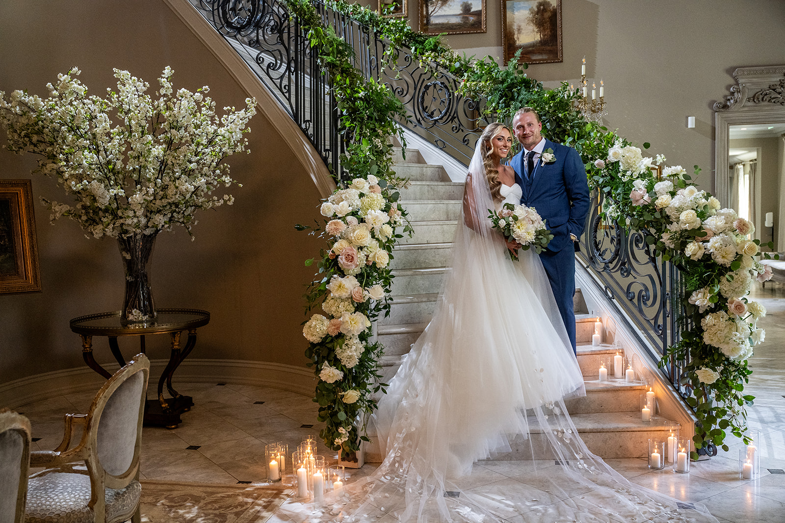 bride and groom on staircase with flowers