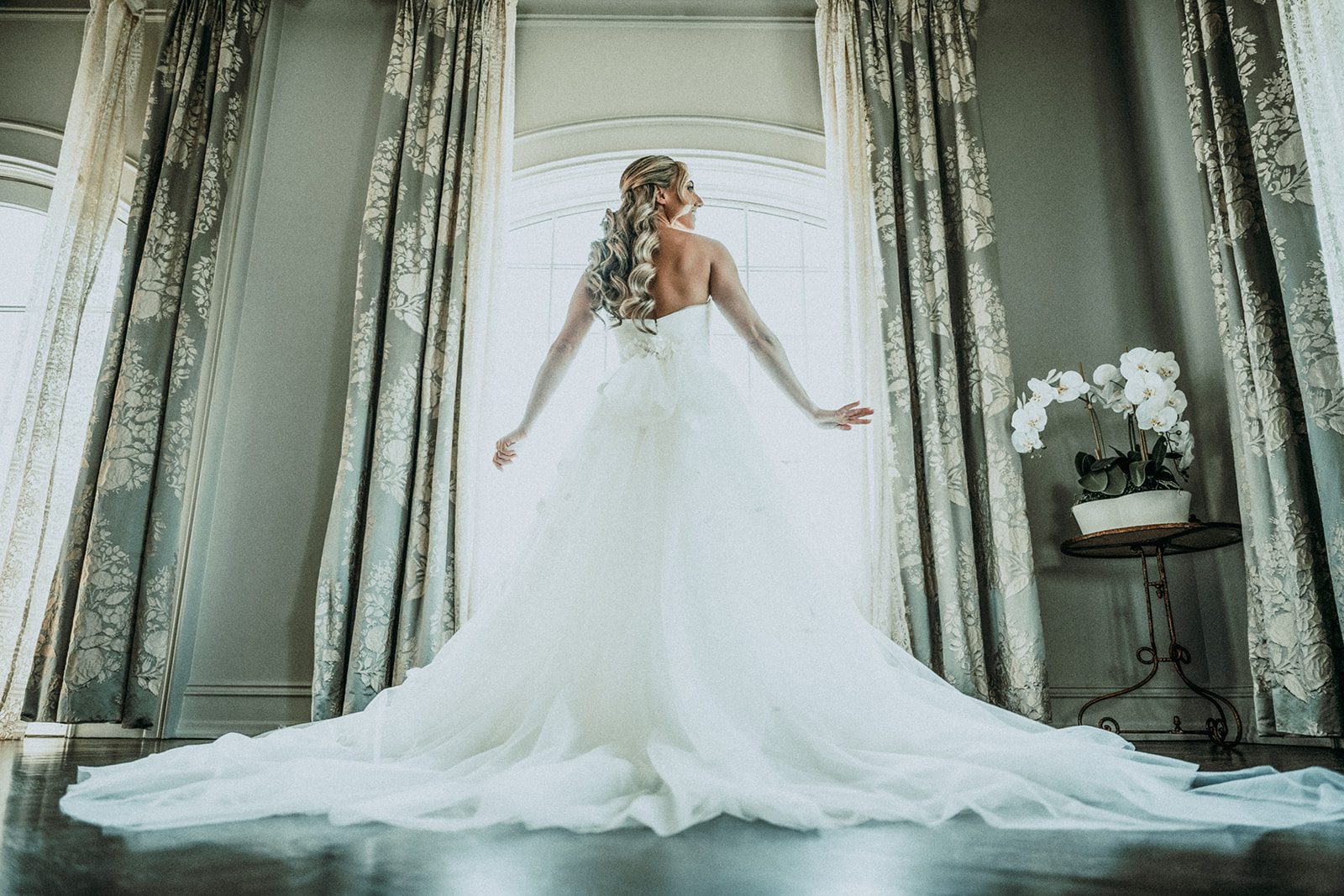 back of bride looking out window