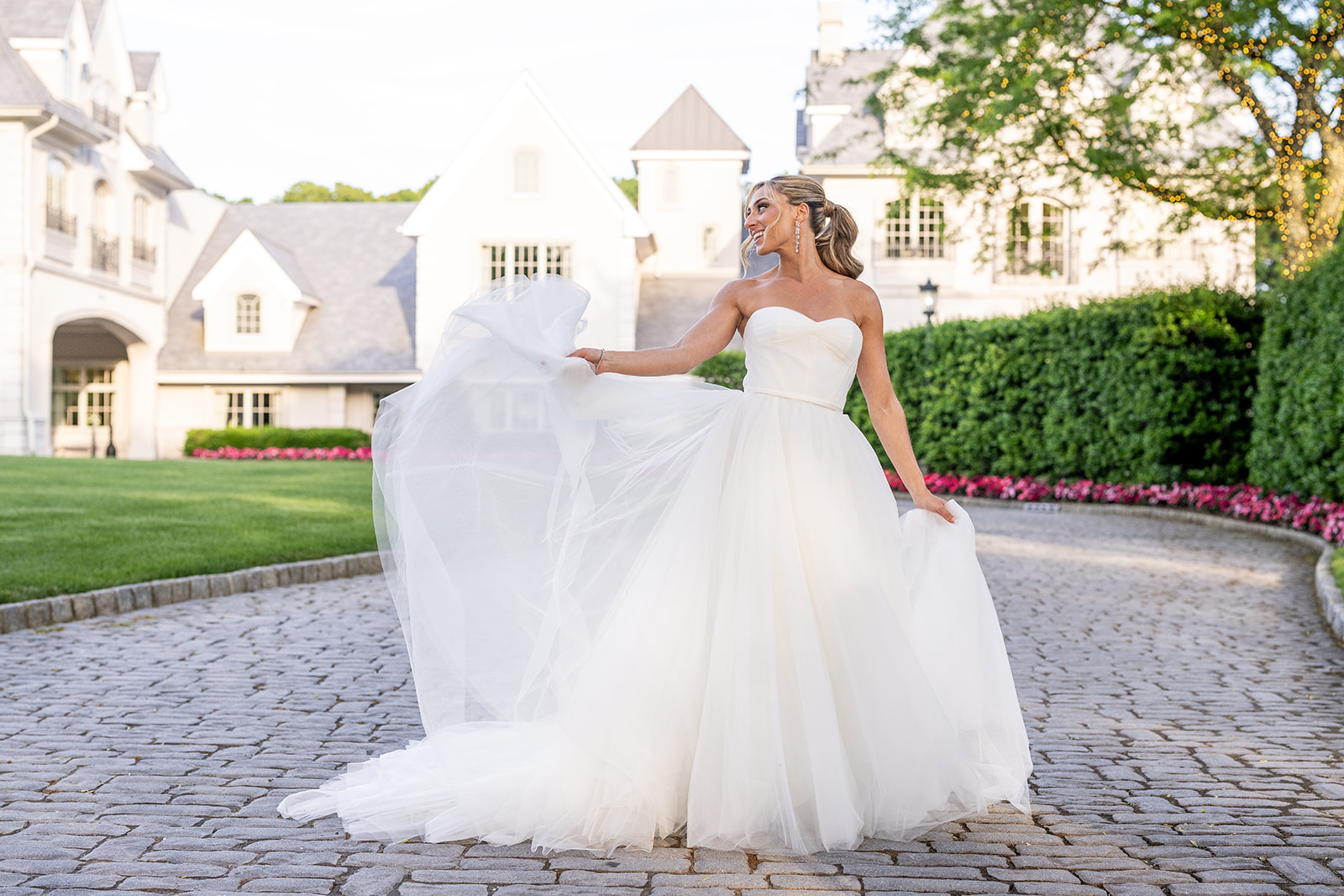 bride playing with her gown standing