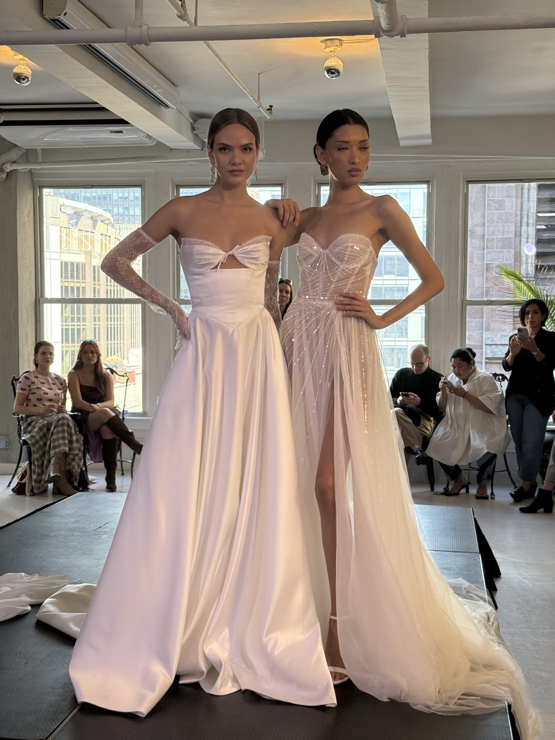 two models wearing wedding gowns