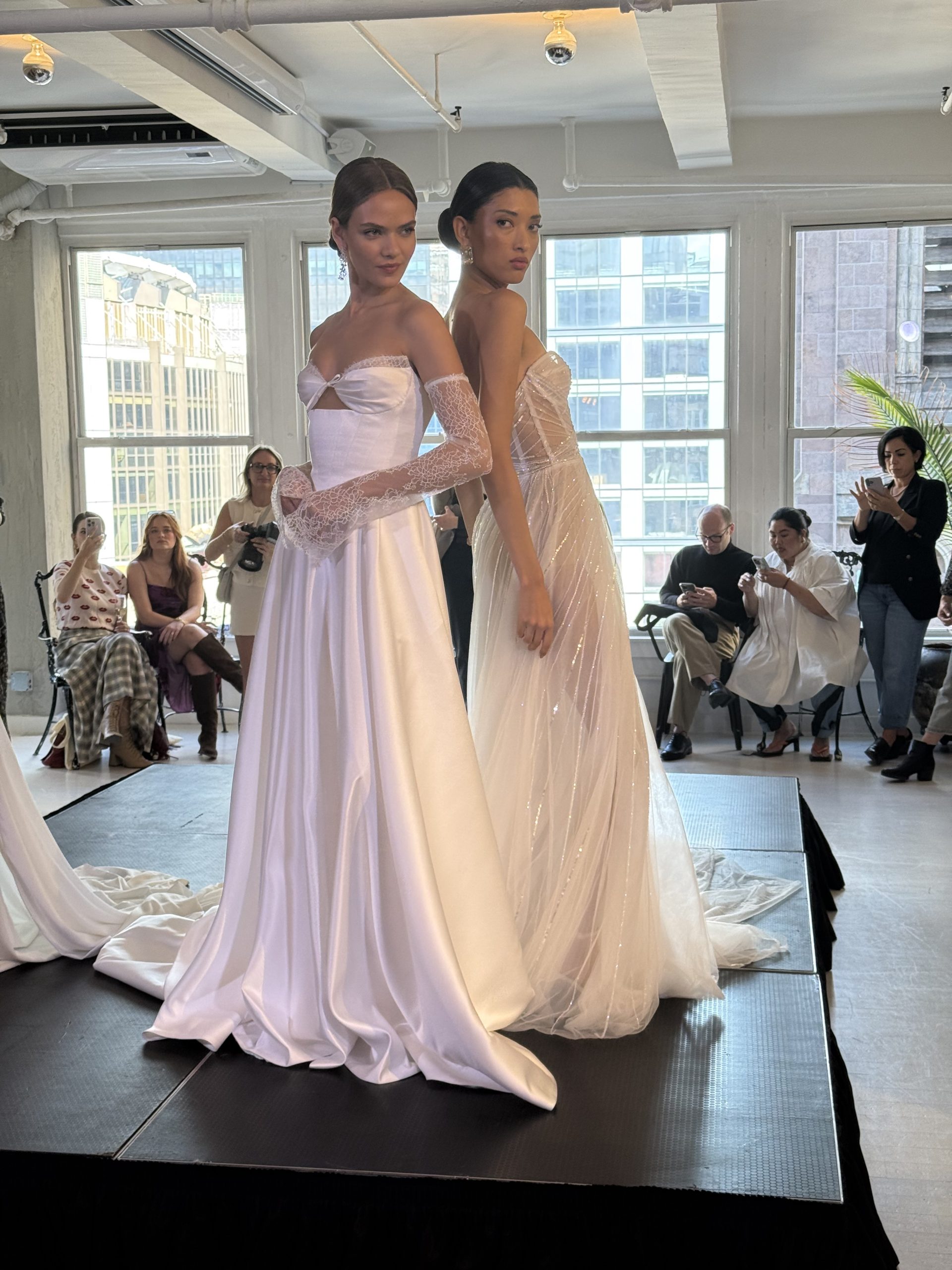 two models wearing high end wedding gowns