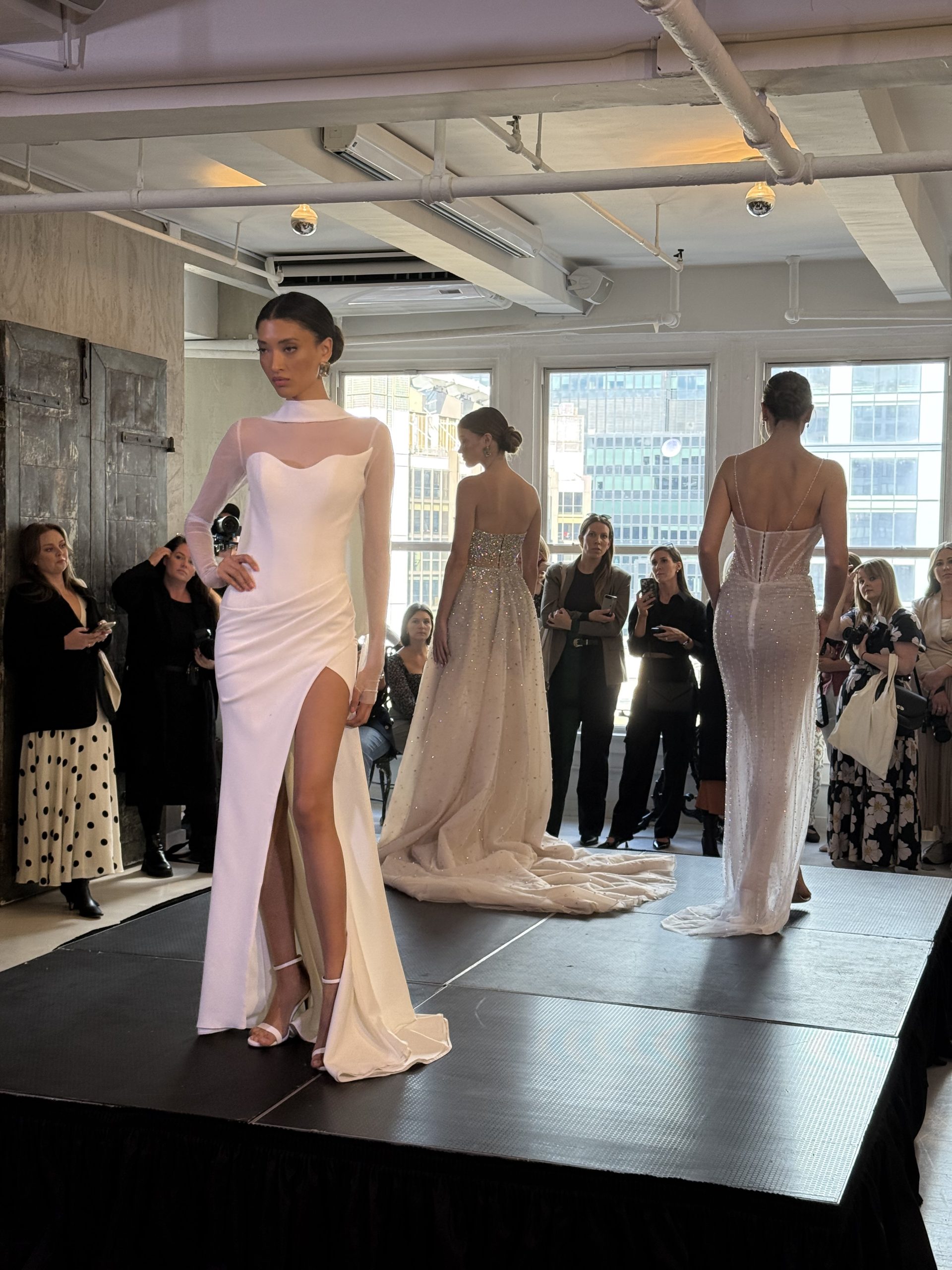 model wearing a wedding gown with sheer sleeves