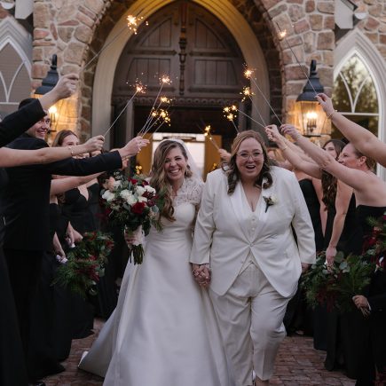 lesbian couple coming out of the chapel after getting married at Park Savoy with sparklers