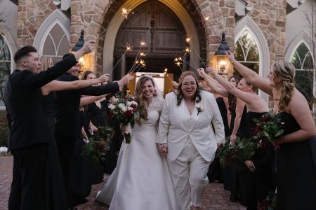 lesbian couple coming out of the chapel after getting married at Park Savoy with sparklers