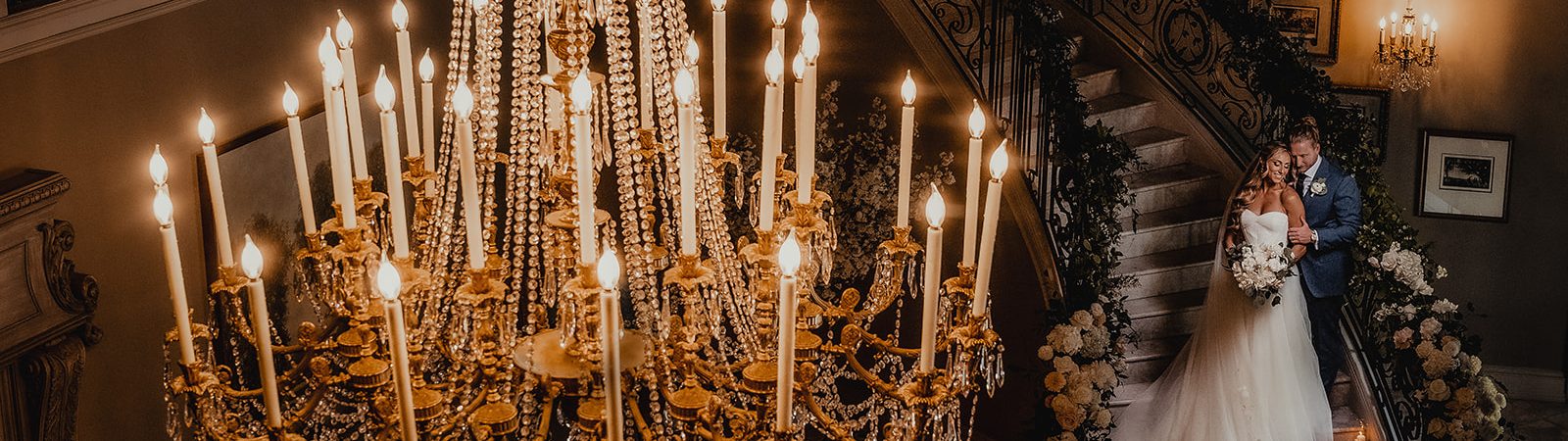 bride and groom with chandelier