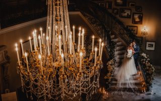 bride and groom with chandelier
