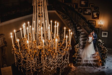 bride and groom with chandelier