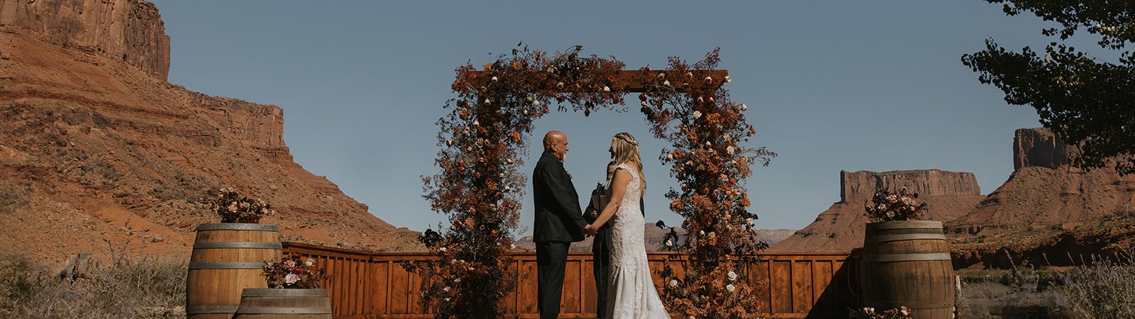 bride and groom at alter for wedding ceremony lots of orange and brown