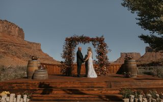 bride and groom at alter for wedding ceremony lots of orange and brown