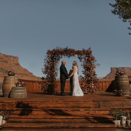 bride and groom at alter for wedding ceremony lots of orange and brown