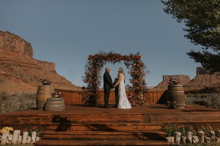 bride and groom at alter for wedding ceremony lots of orange and brown