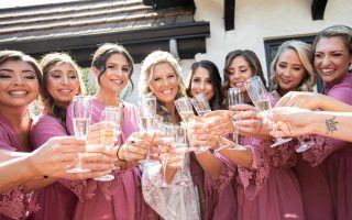 bride and bridesmaids with champagne