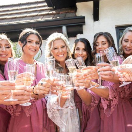 bride and bridesmaids with champagne