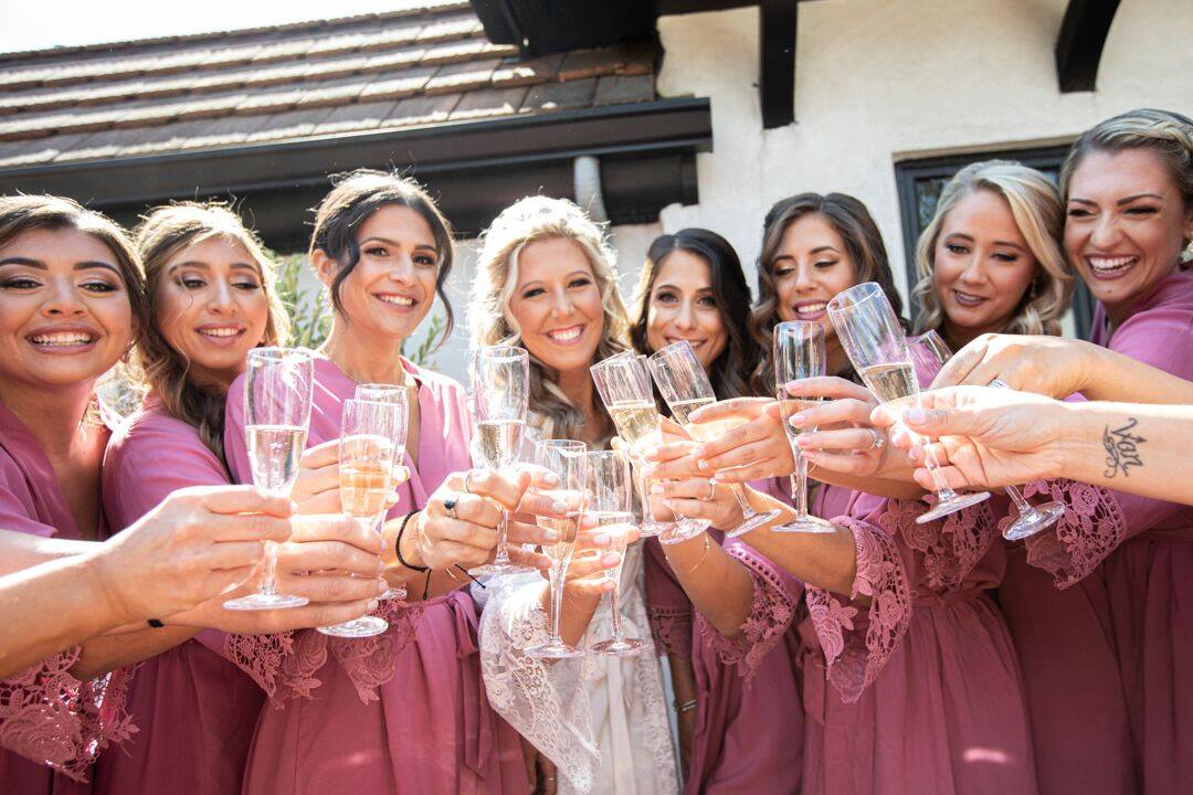 bride and bridesmaids with champagne