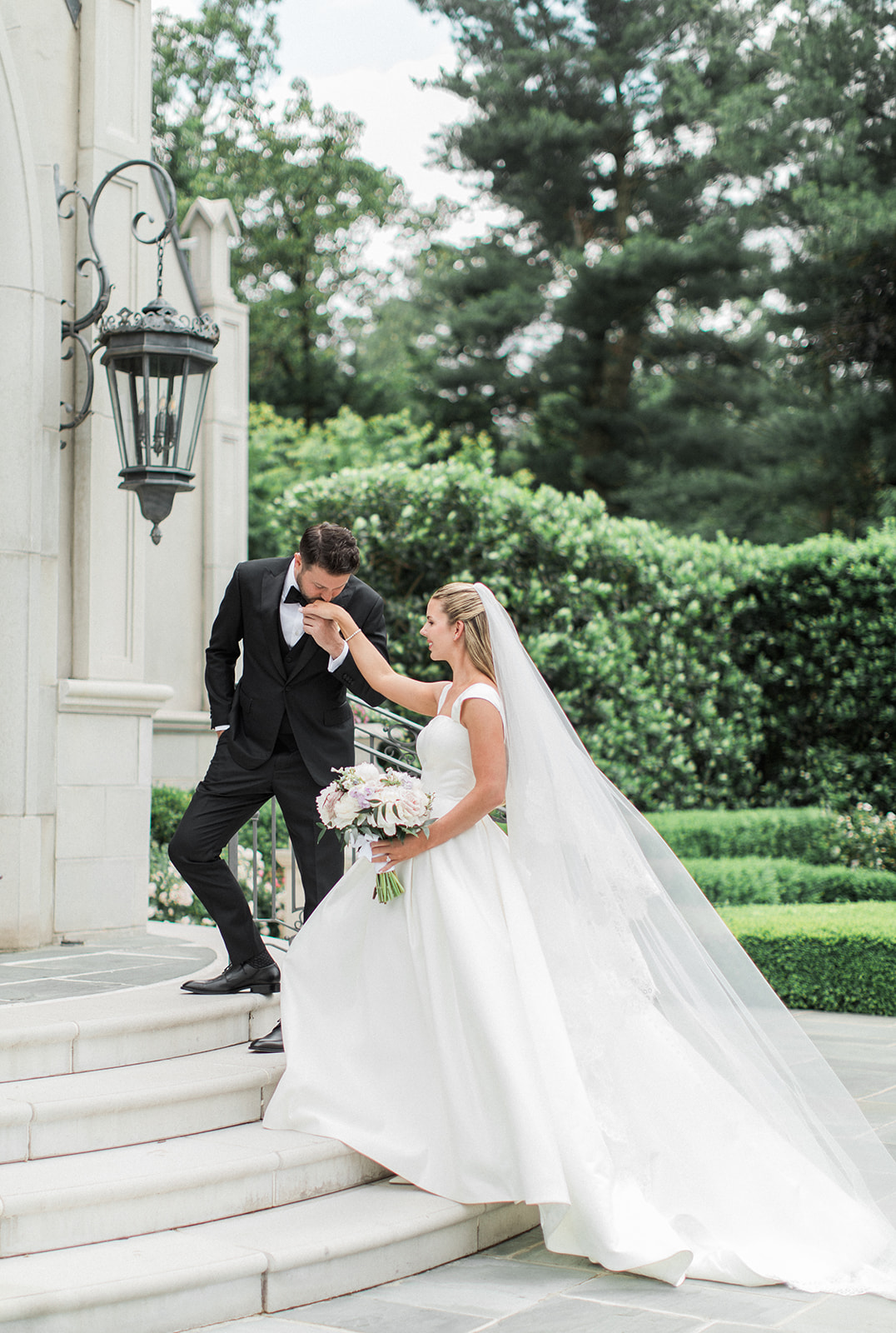 groom kissing brides hand