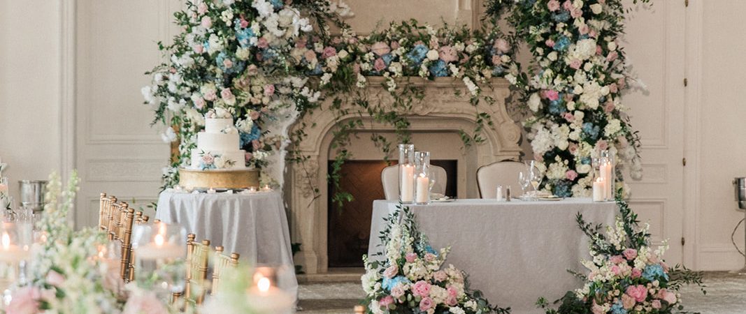 ballroom shot of sweetheart table, cake, and long table