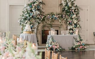 ballroom shot of sweetheart table, cake, and long table