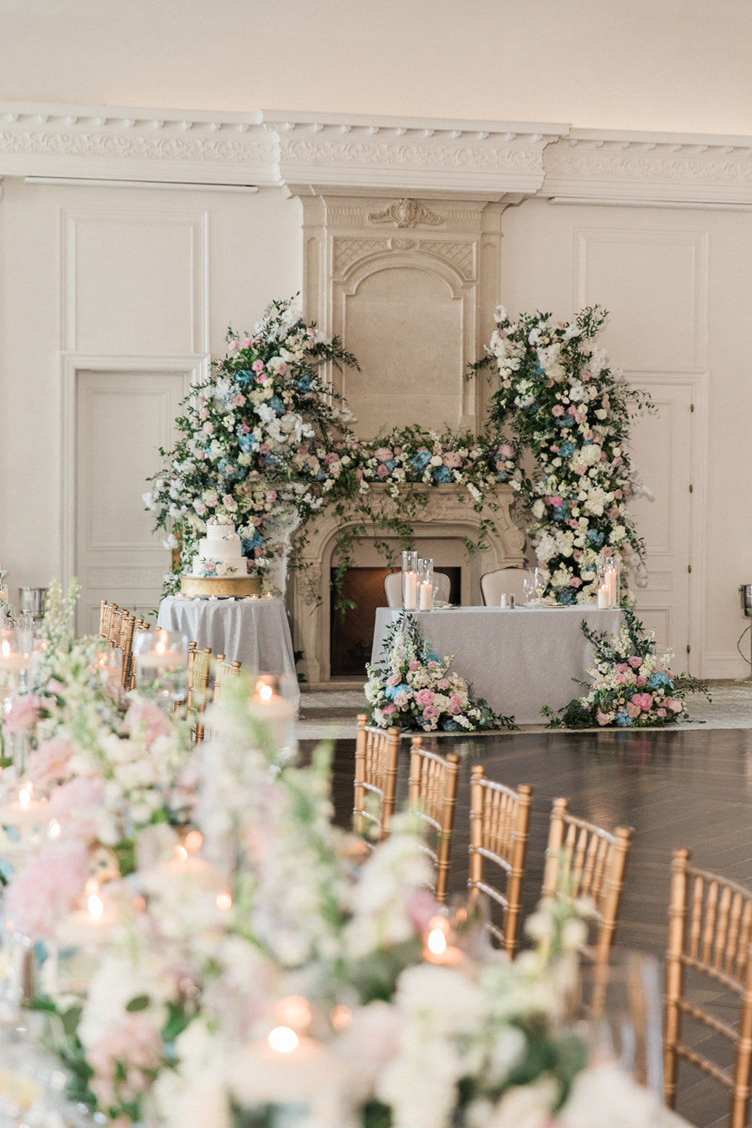 ballroom shot of sweetheart table, cake, and long table