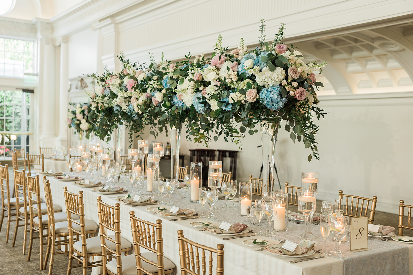 long table of all high centerpieces for a wedding