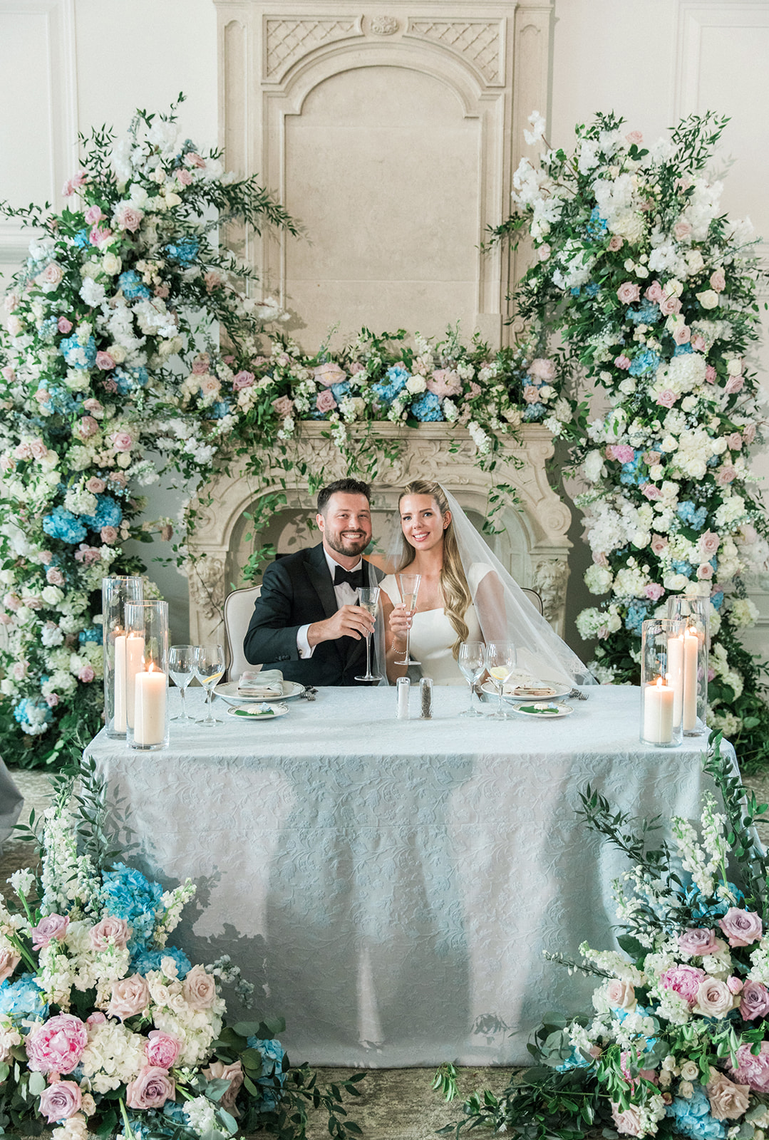 sweetheart table with flowers and bride and groom