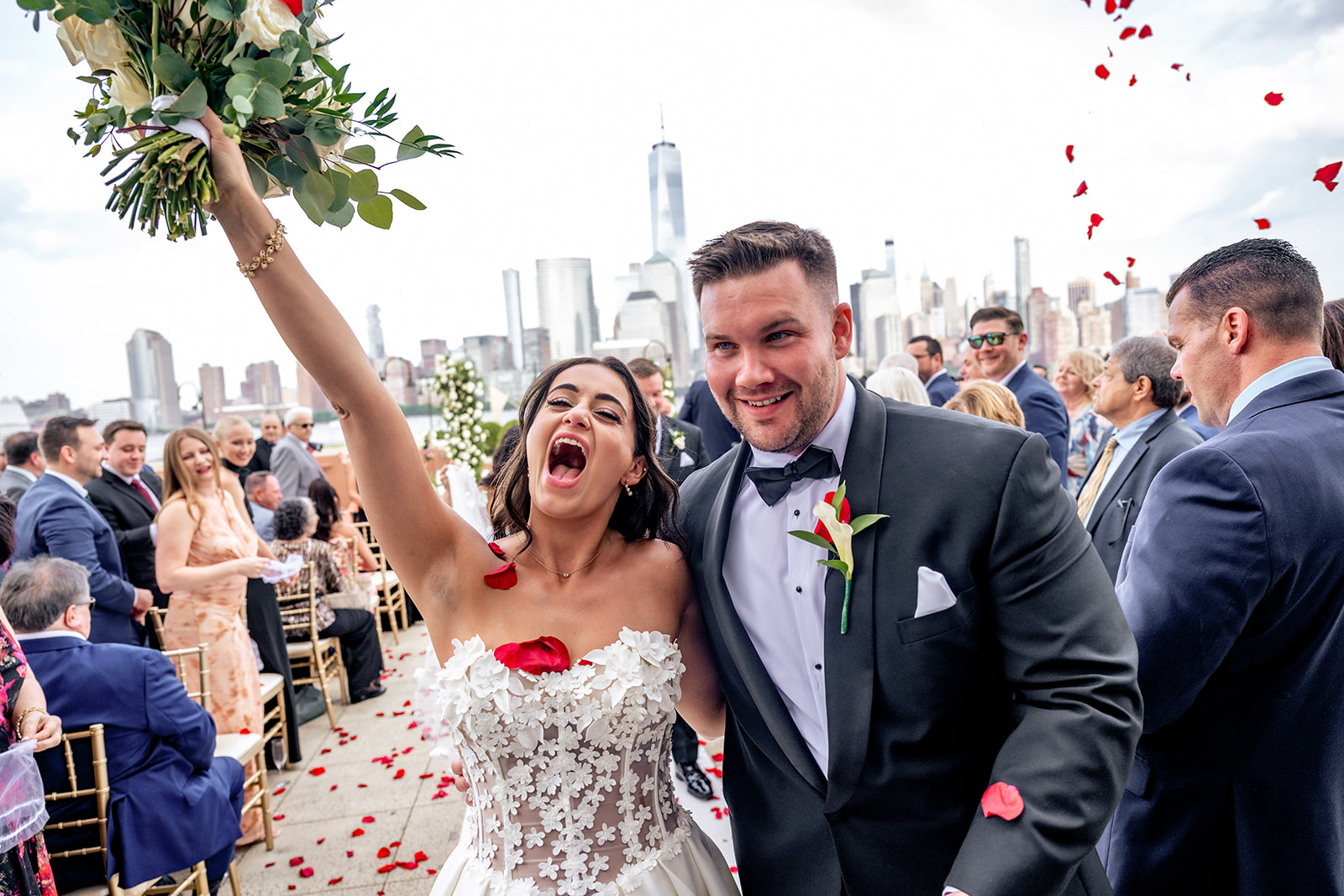 bride and groom down the aisle happy with bouquet