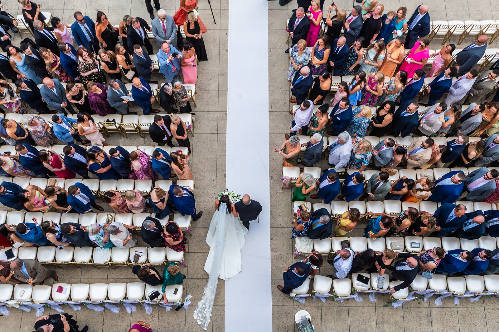 bride and dad walking down the aisle from above
